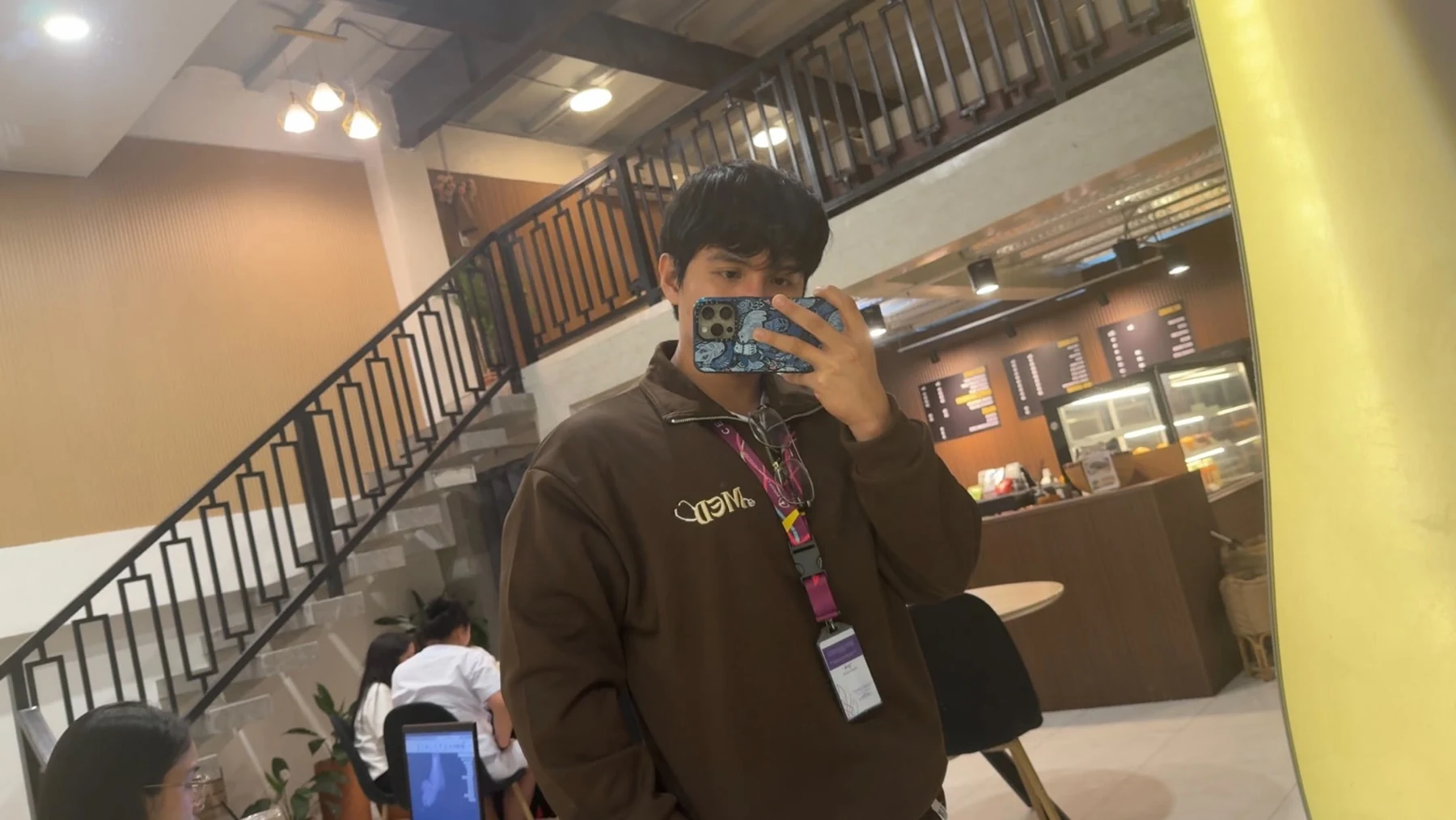 Jake taking a mirror photo on campus